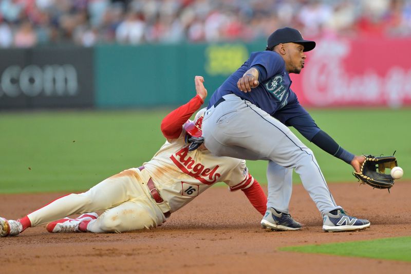 Jul 13, 2024; Anaheim, California, USA;  Mickey Moniak #16 of the Los Angeles Angels beats the throw to Jorge Polanco #7 of the Seattle Mariners for a stolen base in the second inning at Angel Stadium. Mandatory Credit: Jayne Kamin-Oncea-USA TODAY Sports