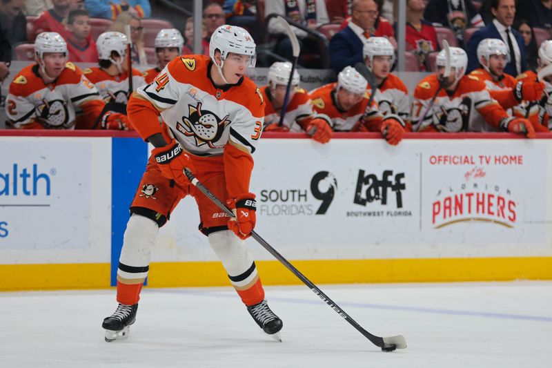 Jan 18, 2025; Sunrise, Florida, USA; Anaheim Ducks defenseman Pavel Mintyukov (34) controls the puck against the Florida Panthers during the first period at Amerant Bank Arena. Mandatory Credit: Sam Navarro-Imagn Images