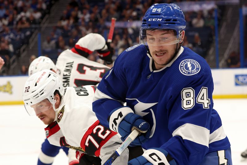 Apr 11, 2024; Tampa, Florida, USA; Tampa Bay Lightning left wing Tanner Jeannot (84) and Ottawa Senators defenseman Thomas Chabot (72) fight to control the puck during the first period at Amalie Arena. Mandatory Credit: Kim Klement Neitzel-USA TODAY Sports