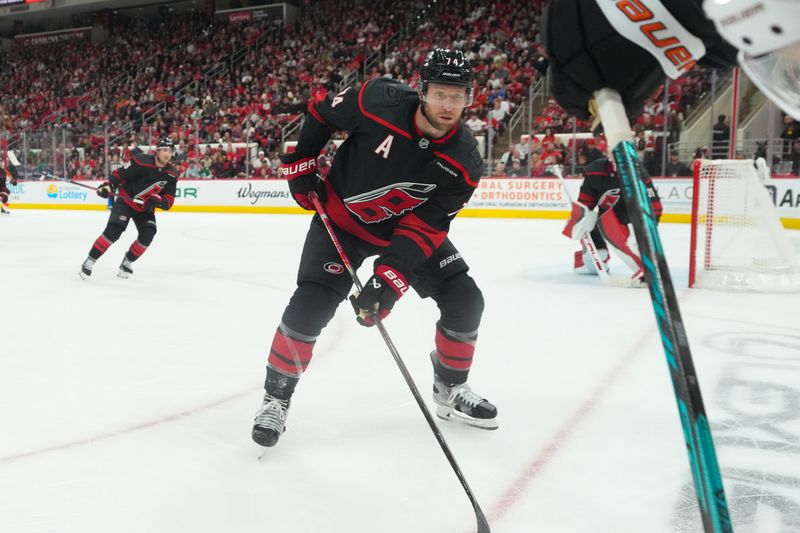Oct 11, 2025; Raleigh, North Carolina, USA;  Carolina Hurricanes defenseman Jaccob Slavin (74) watches the play against the Philadelphia Flyers during the second period at Lenovo Center. Mandatory Credit: James Guillory-Imagn Images