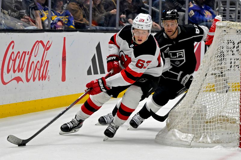 Mar 3, 2024; Los Angeles, California, USA; New Jersey Devils left wing Jesper Bratt (63) takes the puck past Los Angeles Kings center Trevor Lewis (61) in the second period at Crypto.com Arena. Mandatory Credit: Jayne Kamin-Oncea-USA TODAY Sports