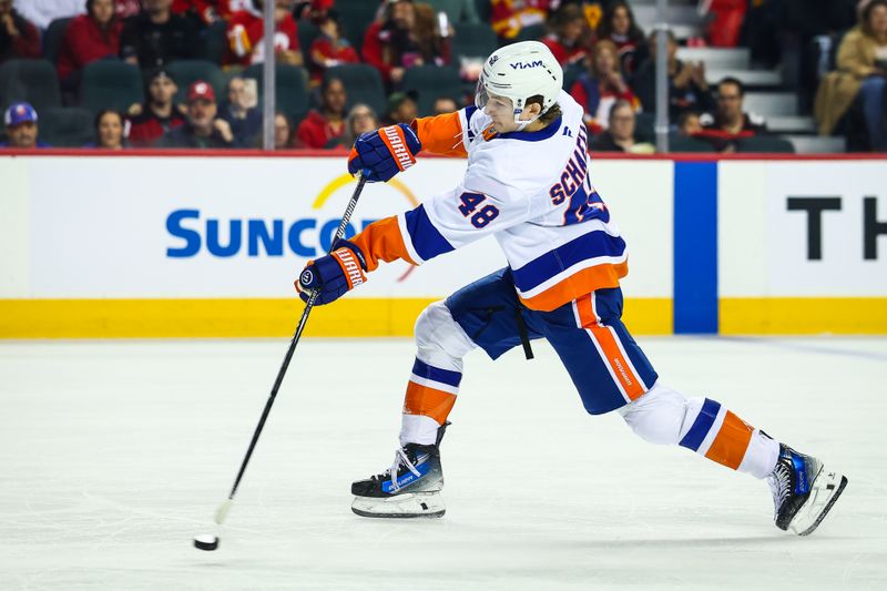 Jan 17, 2026; Calgary, Alberta, CAN; New York Islanders defenseman Matthew Schaefer (48) shoots the puck against the Calgary Flames during the first period at Scotiabank Saddledome. Mandatory Credit: Sergei Belski-Imagn Images