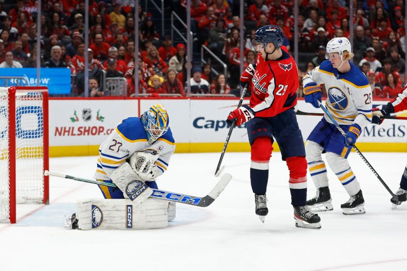 Nov 22, 2023; Washington, District of Columbia, USA; Buffalo Sabres goaltender Devon Levi (27) makes a save in front of Washington Capitals center Hendrix Lapierre (290 and Sabres defenseman Rasmus Dahlin (26) in the third period at Capital One Arena. Mandatory Credit: Geoff Burke-USA TODAY Sports