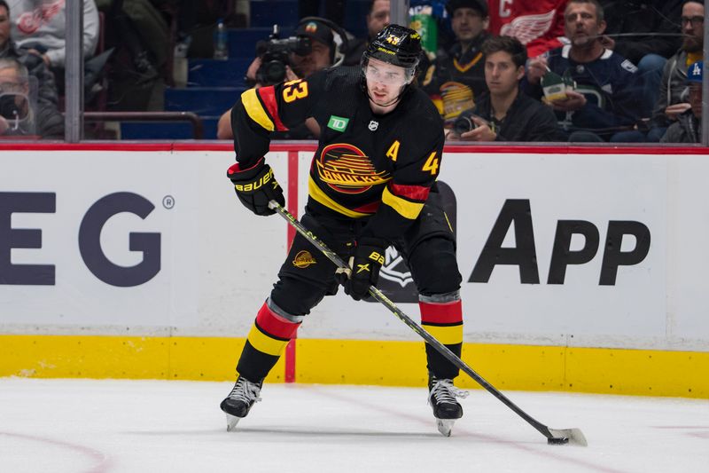 Feb 13, 2023; Vancouver, British Columbia, CAN; Vancouver Canucks defenseman Quinn Hughes (43) handles the puck against the Detroit Red Wings in the second period at Rogers Arena. Mandatory Credit: Bob Frid-USA TODAY Sports