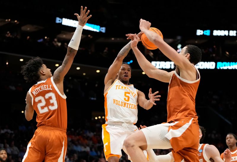 March 23, 2024, Charlotte, NC, USA; Tennessee Volunteers guard Zakai Zeigler (5) passes the ball away from Texas Longhorns forward Dillon Mitchell (23) and Texas Longhorns forward Dylan Disu (1)  in the second round of the 2024 NCAA Tournament at the Spectrum Center. Mandatory Credit: Bob Donnan-USA TODAY Sports