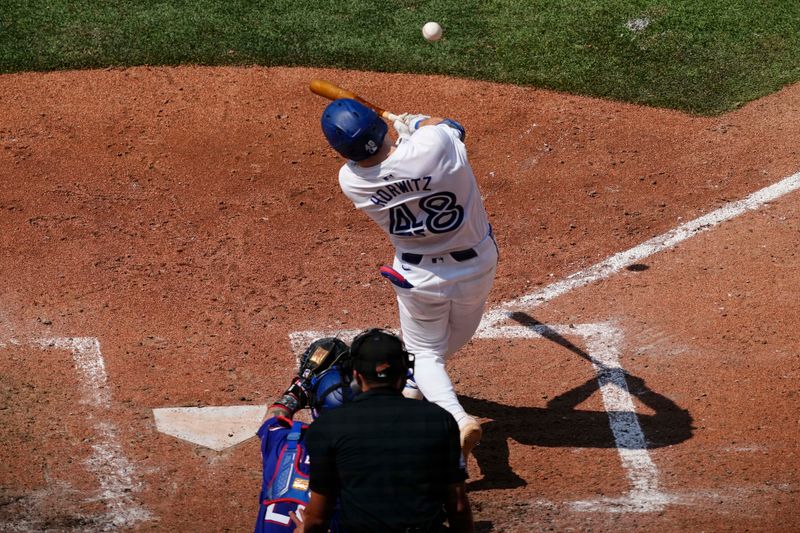 Jul 28, 2024; Toronto, Ontario, CAN; Toronto Blue Jays second baseman Spencer Horwitz (48) makes contact withthe ball against the Texas Rangers during the sixth inning at Rogers Centre. Mandatory Credit: John E. Sokolowski-USA TODAY Sports