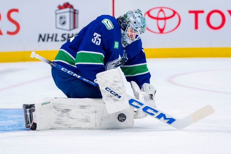 Dec 14, 2024; Vancouver, British Columbia, CAN; Vancouver Canucks goalie Thatcher Demko (35) makes a save during warm up prior to a game against the Boston Bruins at Rogers Arena. Mandatory Credit: Bob Frid-Imagn Images