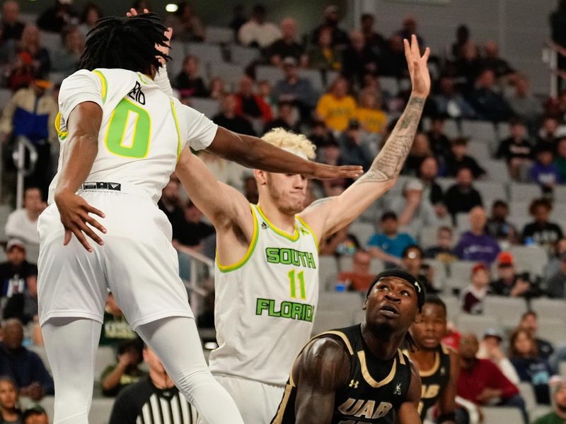 Mar 16, 2024; Fort Worth, TX, USA; UAB Blazers guard Alejandro Vasquez (10) looks to score between South Florida Bulls forward Kasean Pryor (11) and guard Jayden Reid (0) during the first half at Dickies Arena. Mandatory Credit: Chris Jones-USA TODAY Sports