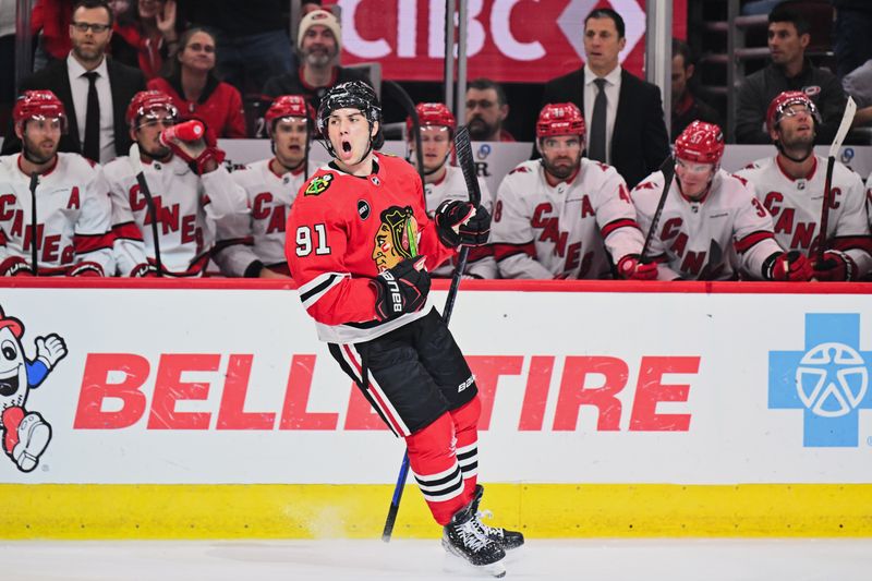 Apr 14, 2024; Chicago, Illinois, USA; Chicago Blackhawks forward Frank Nazar (91) celebrates after scoring his first NHL goal in his NHL debut in the first period against the Carolina Hurricanes at United Center. Mandatory Credit: Jamie Sabau-USA TODAY Sports