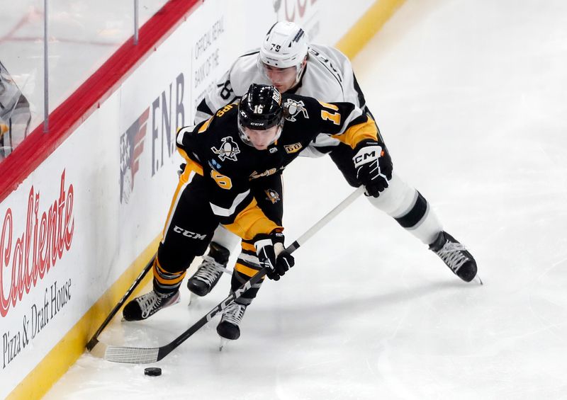 Feb 18, 2024; Pittsburgh, Pennsylvania, USA;  Pittsburgh Penguins right wing Matthew Phillips (16) moves the puck against Los Angeles Kings right wing Alex Laferriere (78) during the second period at PPG Paints Arena. Mandatory Credit: Charles LeClaire-USA TODAY Sports