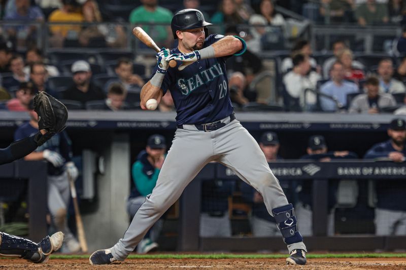 May 21, 2024; Bronx, New York, USA; Seattle Mariners catcher Cal Raleigh (29) is hit by a pitch during the eighth inning against the New York Yankees at Yankee Stadium. Mandatory Credit: Vincent Carchietta-USA TODAY Sports