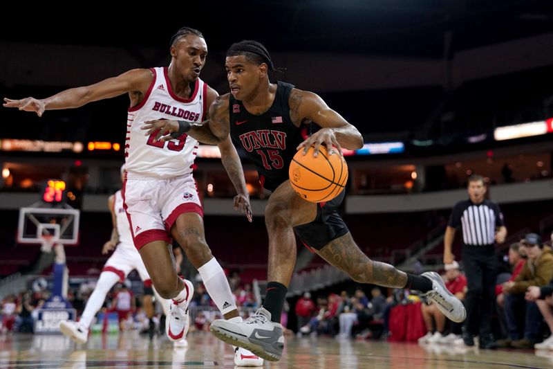 Feb 14, 2024; Fresno, California, USA; UNLV Rebels guard Luis Rodriguez (15) dribbles the ball next to Fresno State Bulldogs guard Leo Colimerio (23) in the first half at the Save Mart Center. Mandatory Credit: Cary Edmondson-USA TODAY Sports