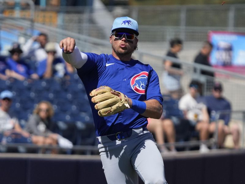 Mar 4, 2024; Peoria, Arizona, USA; Chicago Cubs second baseman Nico Hoerner (2) makes the throw for an out against the San Diego Padres in the first inning at Peoria Sports Complex. Mandatory Credit: Rick Scuteri-USA TODAY Sports