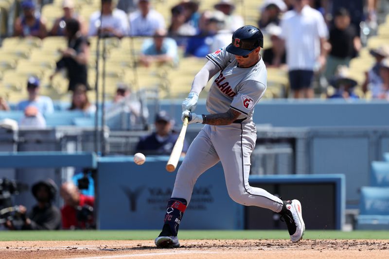 Sep 8, 2024; Los Angeles, California, USA;  Cleveland Guardians shortstop Brayan Rocchio (4) hits a single during the third inning against the Los Angeles Dodgers at Dodger Stadium. Mandatory Credit: Kiyoshi Mio-Imagn Images