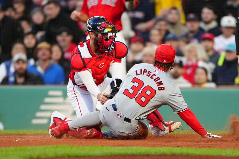 May 10, 2024; Boston, Massachusetts, USA; Washington Nationals third baseman Trey Lipscomb (38) is tagged out by Boston Red Sox catcher Connor Wong (12) while attempting to score on a single hit by Washington Nationals right fielder Victor Robles (not pictured) during the second inning at Fenway Park. Mandatory Credit: Gregory Fisher-USA TODAY Sports