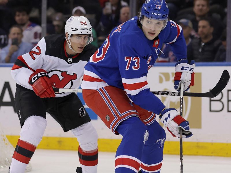 Mar 11, 2024; New York, New York, USA; New York Rangers center Matt Rempe (73) plays the puck against New Jersey Devils left wing Tomas Nosek (92) during the first period at Madison Square Garden. Mandatory Credit: Brad Penner-USA TODAY Sports