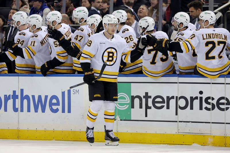 Jan 26, 2026; New York, New York, USA; Boston Bruins center Morgan Geekie (39) celebrates his goal against the New York Rangers with teammates during the second period at Madison Square Garden. Mandatory Credit: Brad Penner-Imagn Images