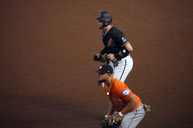 Oct 1, 2023; Phoenix, Arizona, USA; Arizona Diamondbacks designated hitter Evan Longoria (3) leads off first base as Houston Astros first baseman Jose Abreu (79) covers the bag during the fourth inning at Chase Field. Mandatory Credit: Joe Camporeale-USA TODAY Sports