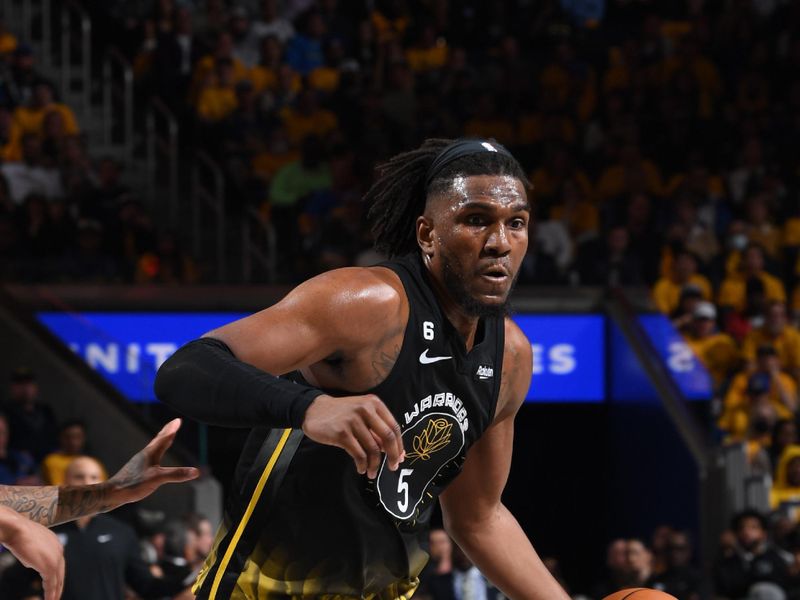 SAN FRANCISCO, CA - APRIL 20: Kevon Looney #5 of the Golden State Warriors dribbles the ball during the game against the Sacramento Kings during Round One Game Three of the 2023 NBA Playoffs on April 20, 2023 at Chase Center in San Francisco, California. NOTE TO USER: User expressly acknowledges and agrees that, by downloading and or using this photograph, user is consenting to the terms and conditions of Getty Images License Agreement. Mandatory Copyright Notice: Copyright 2023 NBAE (Photo by Noah Graham/NBAE via Getty Images)