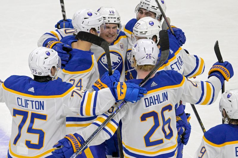 Feb 17, 2024; Saint Paul, Minnesota, USA;  Buffalo Sabres defenseman Henri Jokiharju (10) is swarmed by teammates after scoring the game-winning overtime goal against the Minnesota Wild at Xcel Energy Center. Mandatory Credit: Nick Wosika-USA TODAY Sports