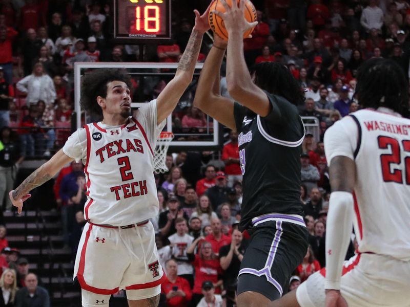 Jan 13, 2024; Lubbock, Texas, USA;  Texas Tech Red Raiders guard Pop Issacs (2) tries to steal the ball from Kansas State Wildcats center Will McNair Jr. (13) in the second half at United Supermarkets Arena. Mandatory Credit: Michael C. Johnson-USA TODAY Sports