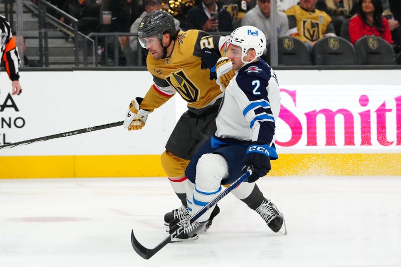 Nov 2, 2023; Las Vegas, Nevada, USA; Vegas Golden Knights center Chandler Stephenson (20) overtakes Winnipeg Jets defenseman Dylan DeMelo (2) during the third period at T-Mobile Arena. Mandatory Credit: Stephen R. Sylvanie-USA TODAY Sports