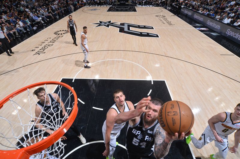 SAN ANTONIO, TX - APRIL 12:  Sandro Mamukelashvili #54 of the San Antonio Spurs  goes to the basket during the game on April 12, 2024 at the Frost Bank Center in San Antonio, Texas. NOTE TO USER: User expressly acknowledges and agrees that, by downloading and or using this photograph, user is consenting to the terms and conditions of the Getty Images License Agreement. Mandatory Copyright Notice: Copyright 2024 NBAE (Photos by Michael Gonzales/NBAE via Getty Images)