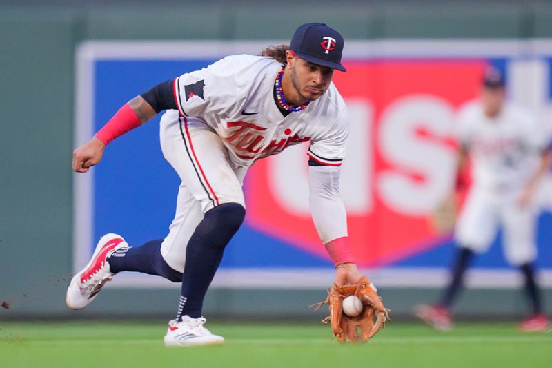 Aug 13, 2024; Minneapolis, Minnesota, USA; Minnesota Twins second baseman Austin Martin (82) fields a ground ball against the Kansas City Royals in the sixth inning at Target Field. Mandatory Credit: Brad Rempel-USA TODAY Sports