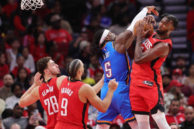 HOUSTON, TEXAS - DECEMBER 01: Tari Eason #17 of the Houston Rockets pulls in a rebound over Luguentz Dort #5 of the Oklahoma City Thunder during the first half at Toyota Center on December 01, 2024 in Houston, Texas. NOTE TO USER: User expressly acknowledges and agrees that, by downloading and or using this photograph, User is consenting to the terms and conditions of the Getty Images License Agreement. (Photo by Alex Slitz/Getty Images)