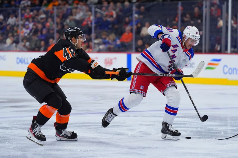 Nov 29, 2024; Philadelphia, Pennsylvania, USA; Philadelphia Flyers center Morgan Frost (48) defends New York Rangers right wing Reilly Smith (91) in the second period at Wells Fargo Center. Mandatory Credit: Kyle Ross-Imagn Images