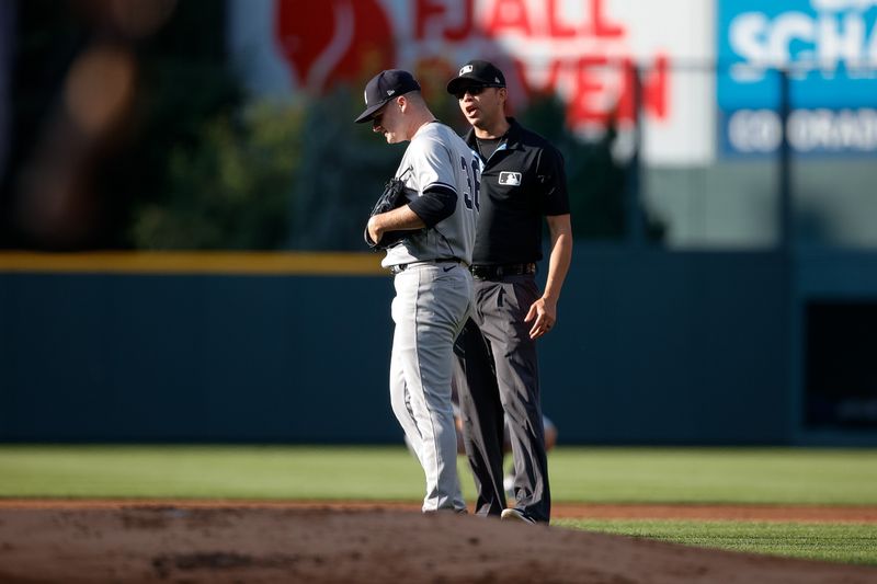 Jul 15, 2023; Denver, Colorado, USA; New York Yankees starting pitcher Clarke Schmidt (36) talks with second base umpire Emil Jimenez (82) after a balk call in the first inning against the Colorado Rockies at Coors Field. Mandatory Credit: Isaiah J. Downing-USA TODAY Sports