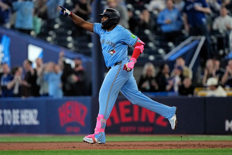 May 29, 2025; Toronto, Ontario, CAN; Toronto Blue Jays first baseman Vladimir Guerrero (27) celebrates as he runs the bases on his two run home run against the Athletics during the second inning at Rogers Centre. Mandatory Credit: John E. Sokolowski-Imagn Images