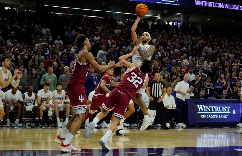 Feb 15, 2023; Evanston, Illinois, USA; Northwestern Wildcats guard Boo Buie (0) shoots the game winning basket over Indiana Hoosiers guard Trey Galloway (32) during the second half at Welsh-Ryan Arena. Mandatory Credit: David Banks-USA TODAY Sports