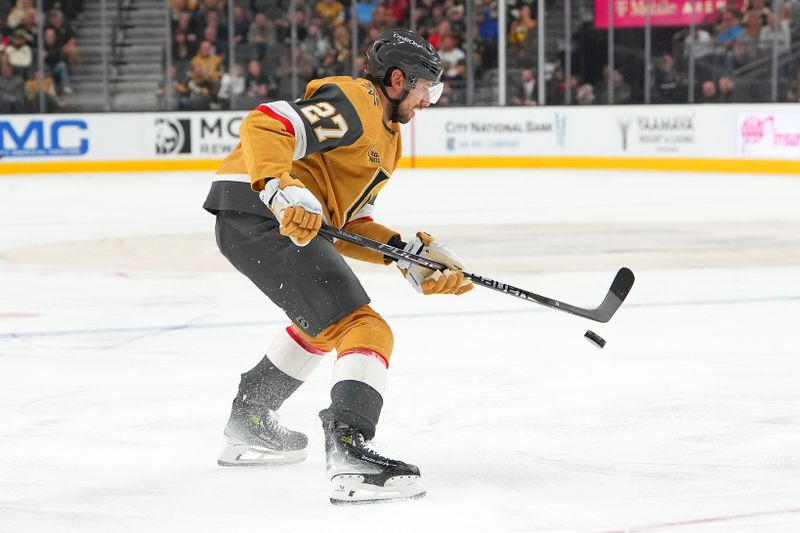 Nov 10, 2025; Las Vegas, Nevada, USA; Vegas Golden Knights defenseman Shea Theodore (27) attempts to control a bouncing puck during a power play against the Florida Panthers in the second period at T-Mobile Arena. Mandatory Credit: Stephen R. Sylvanie-Imagn Images