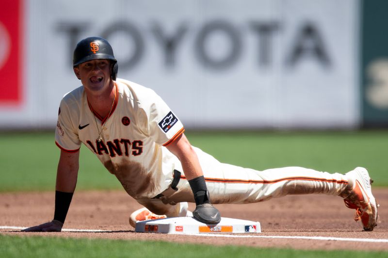 Aug 15, 2024; San Francisco, California, USA; San Francisco Giants shortstop Tyler Fitzgerald (49) looks up at the dugout after successfully stealing third base against the Atlanta Braves during the first inning at Oracle Park. Mandatory Credit: D. Ross Cameron-USA TODAY Sports