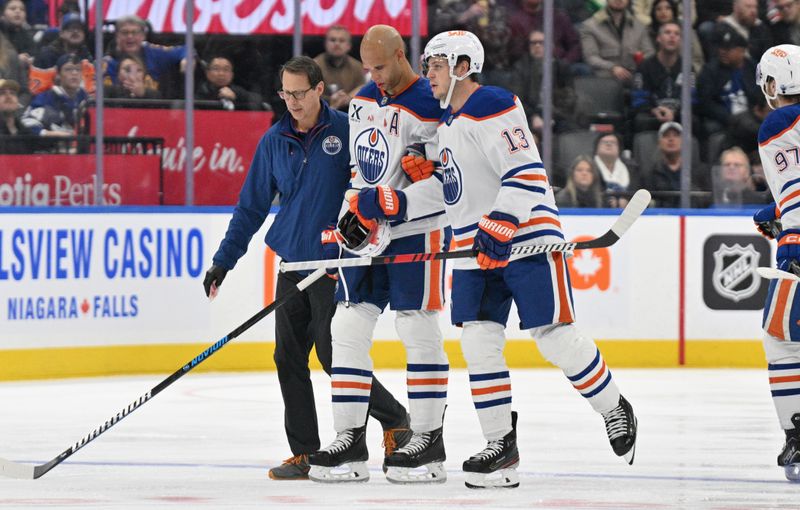 Nov 16, 2024; Toronto, Ontario, CAN;  Edmonton Oilers defenseman Darnell Nurse (25) is helped off the ice after suffering an apparent injury on a bodycheck from Toronto Maple Leafs forward Ryan Reaves (not shown) in the second period at Scotiabank Arena. Mandatory Credit: Dan Hamilton-Imagn Images