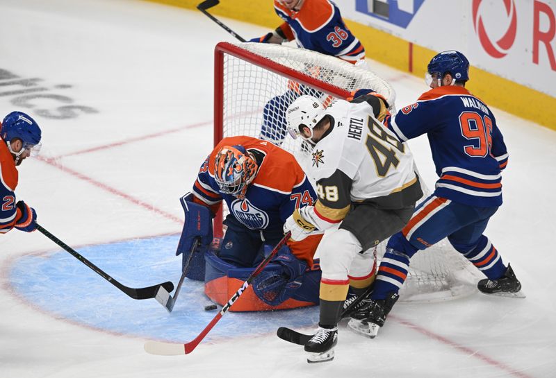 May 12, 2025; Edmonton, Alberta, CAN; Edmonton Oilers goalie Stuart Skinner (74) and and defenseman Jake Walman (96 )battles for the puck with Vegas Golden Knights center Tomas Hertl (48) during the second period in game three of the second round of the 2025 Stanley Cup Playoffs at Rogers Place. Mandatory Credit: Walter Tychnowicz-Imagn Images