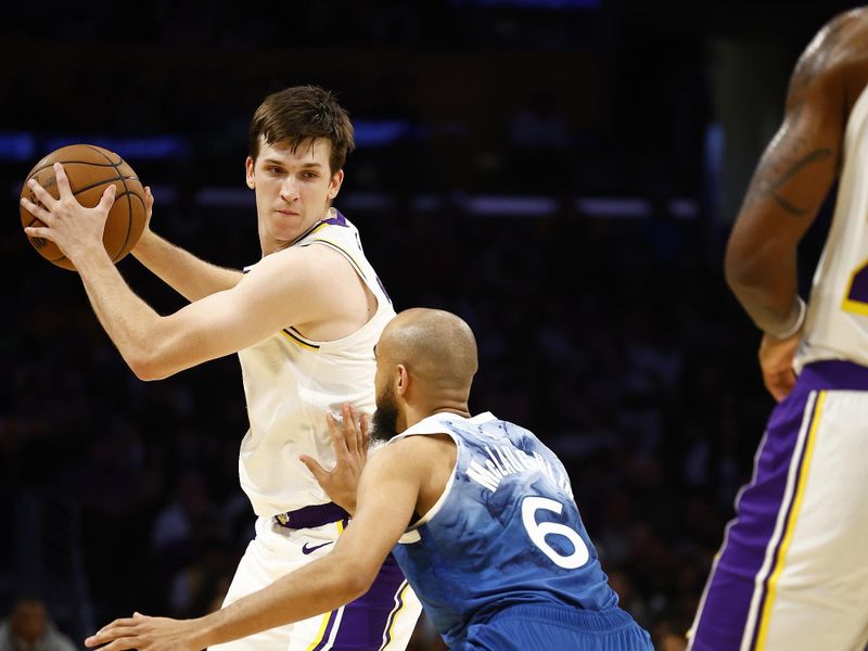 LOS ANGELES, CALIFORNIA - MARCH 10:  Austin Reaves #15 of the Los Angeles Lakers controls the ball against Jordan McLaughlin #6 of the Minnesota Timberwolves in the first half at Crypto.com Arena on March 10, 2024 in Los Angeles, California.  NOTE TO USER: User expressly acknowledges and agrees that, by downloading and/or using this photograph, user is consenting to the terms and conditions of the Getty Images License Agreement.  (Photo by Ronald Martinez/Getty Images)