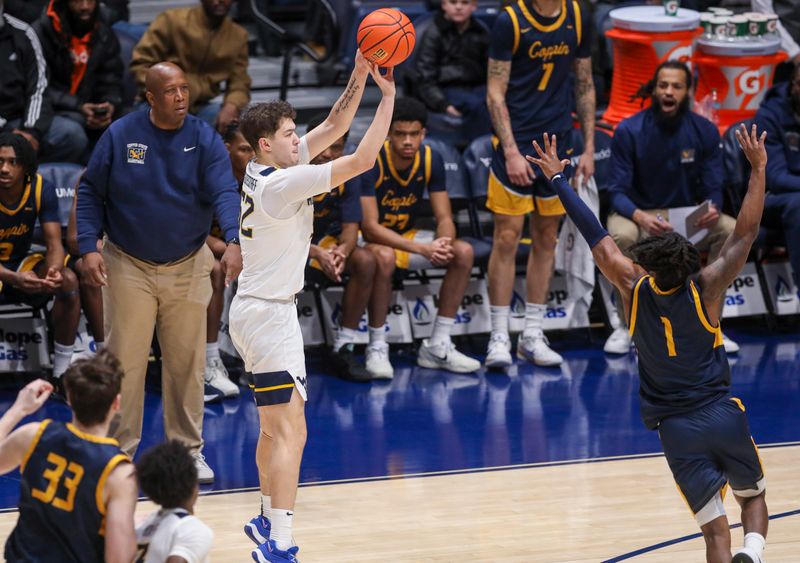 Dec 3, 2025; Morgantown, West Virginia, USA; West Virginia Mountaineers guard Treysen Eaglestaff (52) shoots a three pointer over Coppin State Eagles guard Hassan Perkins (1) during the first half at Hope Coliseum. Mandatory Credit: Ben Queen-Imagn Images