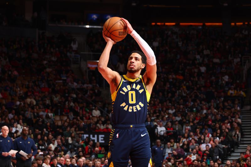 TORONTO, CANADA - APRIL 9:  Tyrese Haliburton #0 of the Indiana Pacers shoots a free throw during the game on April 9, 2024 at the Scotiabank Arena in Toronto, Ontario, Canada.  NOTE TO USER: User expressly acknowledges and agrees that, by downloading and or using this Photograph, user is consenting to the terms and conditions of the Getty Images License Agreement.  Mandatory Copyright Notice: Copyright 2024 NBAE (Photo by Vaughn Ridley/NBAE via Getty Images)