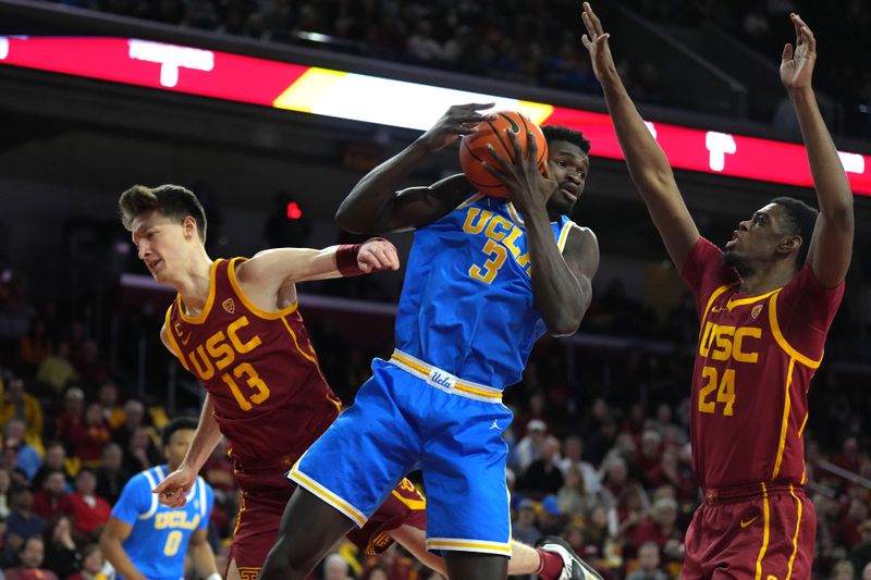 Jan 26, 2023; Los Angeles, California, USA; UCLA Bruins forward Adem Bona (3) battles for the ball with Southern California Trojans guard Drew Peterson (13) and forward Joshua Morgan (24) at Galen Center. Mandatory Credit: Kirby Lee-USA TODAY Sports