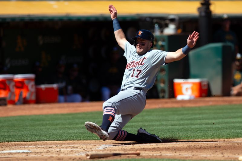 Sep 8, 2024; Oakland, California, USA; Detroit Tigers third baseman Jace Jung (17) slides safely home on a base hit against the Oakland Athletics during the third inning at Oakland-Alameda County Coliseum. Mandatory Credit: D. Ross Cameron-Imagn Images