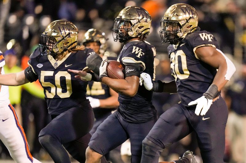 Nov 19, 2022; Winston-Salem, North Carolina, USA;  Wake Forest Demon Deacons defensive back Brendon Harris (18) runs back an interception for a score against the Syracuse Orange during the second half at Truist Field. Mandatory Credit: Jim Dedmon-USA TODAY Sports