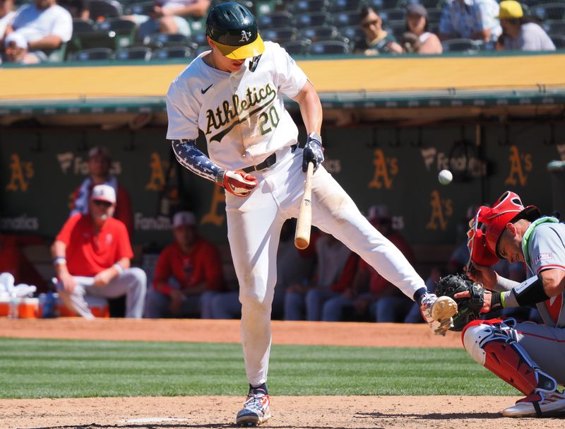 Jul 4, 2024; Oakland, California, USA; Oakland Athletics second baseman Zack Gelof (20) avoids the ball ahead of Los Angeles Angels catcher Logan O'Hoppe (14) during the eighth inning at Oakland-Alameda County Coliseum. Mandatory Credit: Kelley L Cox-USA TODAY Sports