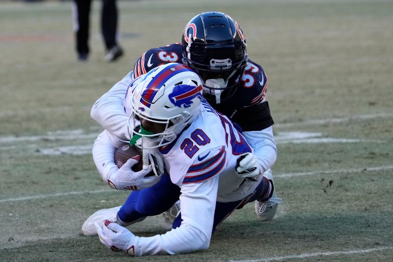 Buffalo Bills running back Nyheim Hines (20) is tackled Chicago Bears cornerback Josh Blackwell during the second half of an NFL football game, Saturday, Dec. 24, 2022, in Chicago. The Bills won 35-13. (AP Photo/Nam Y. Huh)