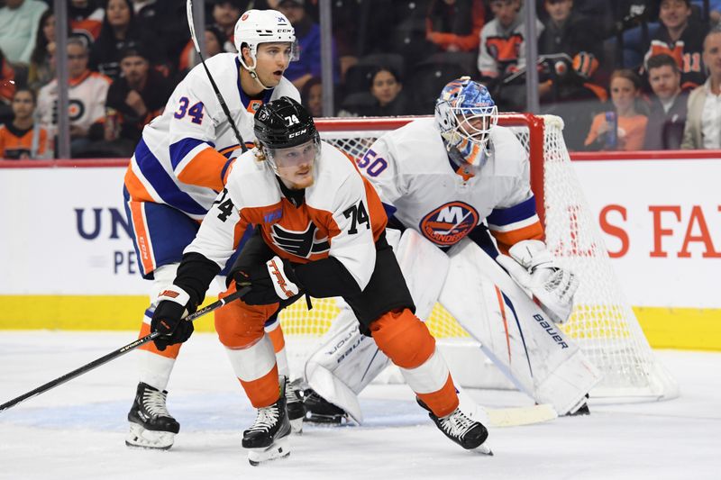 Sep 26, 2024; Philadelphia, Pennsylvania, USA; Philadelphia Flyers right wing Owen Tippett (74) and New York Islanders defenseman Grant Hutton (34) battle for position in front of goaltender Marcus Hogberg (50) during the second period at Wells Fargo Center. Mandatory Credit: Eric Hartline-Imagn Images