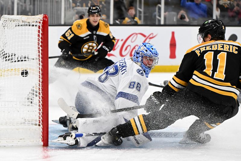 Jan 14, 2025; Boston, Massachusetts, USA; Boston Bruins center Trent Frederic (88) scores against Tampa Bay Lightning goaltender Andrei Vasilevskiy (88) during the first period at the TD Garden. Mandatory Credit: Brian Fluharty-Imagn Images