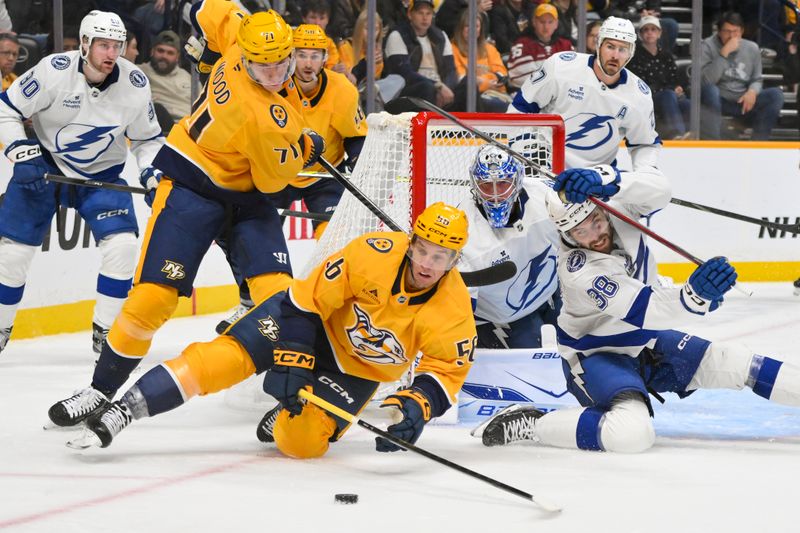 Oct 28, 2025; Nashville, Tennessee, USA;  Nashville Predators left wing Erik Haula (56) and Tampa Bay Lightning left wing Brandon Hagel (38) battle for the puck during the third period at Bridgestone Arena. Mandatory Credit: Steve Roberts-Imagn Images