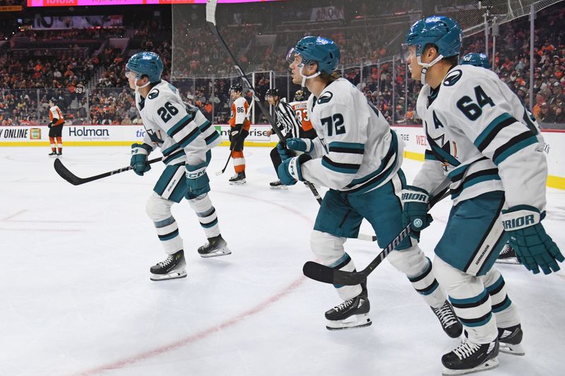 Nov 11, 2024; Philadelphia, Pennsylvania, USA; San Jose Sharks defenseman Jack Thompson (26) skates back to the bench with teammates left wing William Eklund (72) and center Mikael Granlund (64) after scoring a goal against the Philadelphia Flyers during the second period at Wells Fargo Center. Mandatory Credit: Eric Hartline-Imagn Images