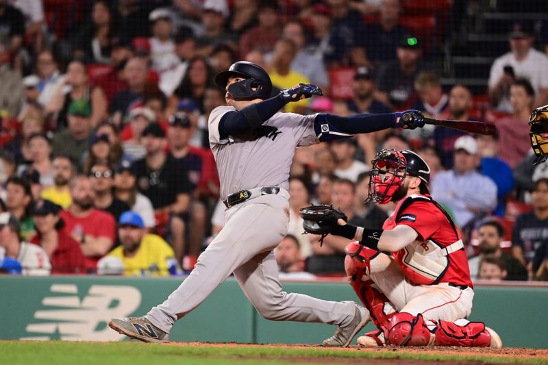 Jun 14, 2024; Boston, Massachusetts, USA; New York Yankees catcher Jose Trevino (39) hits a home run against the Boston Red Sox during the ninth inning at Fenway Park. Mandatory Credit: Eric Canha-USA TODAY Sports